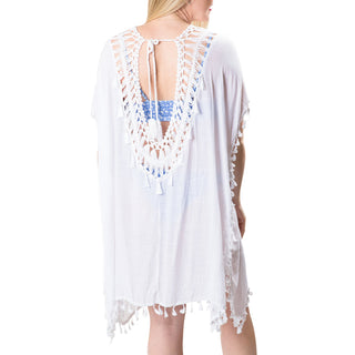 White Cassandra cover-up with tassel on hems and sleeves, open knit v-neck-line and side slits, back view
