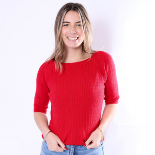 Woman smiling in bold red Kit Top ribbed knit half sleeve sweater.