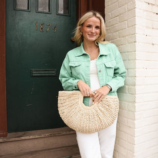 Women wearing green jacket paired with white jeans