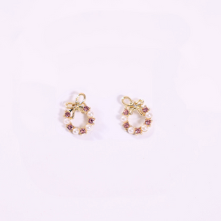Product Shot: Festive holiday wreath earrings with pearls, rhinestones, and bow detail.