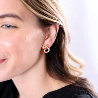 Model Wearing Red Wreath Earrings: Woman wearing red rhinestone wreath earrings with bow accent, holiday jewelry.