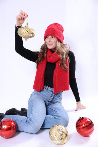 Woman in festive attire with Christmas ornaments on a white background