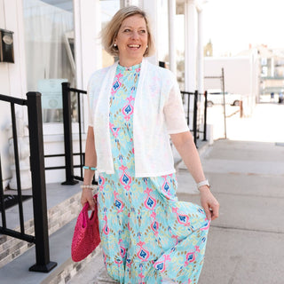 Woman wearing a multi colored dress while walking down the street