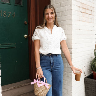 Women wearing white eyelet top with dark wash jeans