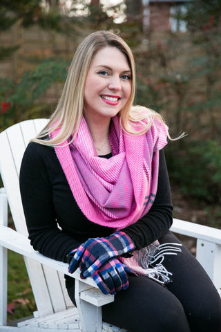 Woman wearing pink scarf and blue pink and white plaid gloves