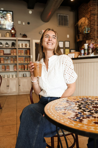 Women wearing white eyelet top with jeans