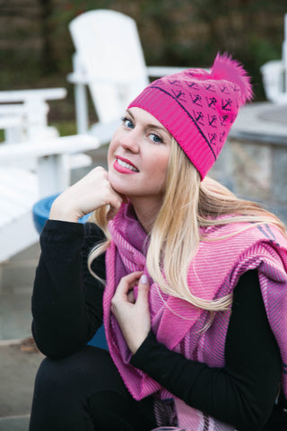 Model sitting wearing scarf and hat