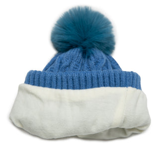 Azure cable knit beanie hat with coordinating pom pom and cream fleece lining, folded to show lining.