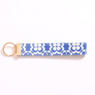 Printed Game Loop keychain in blue and white floral pattern.