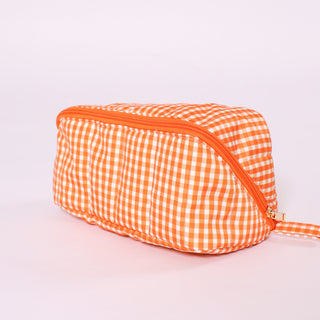 Orange and white gingham fold flat toiletry bag with  zipper
