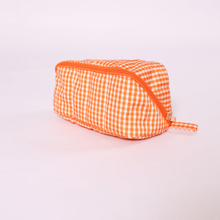 Bright orange gingham glam toiletry and makeup bag with zipper closure.