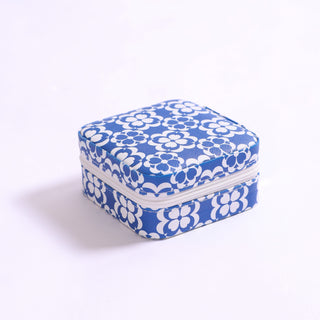 Travel jewelry case with blue and white mosaic-inspired pattern, compact with zipper closure.