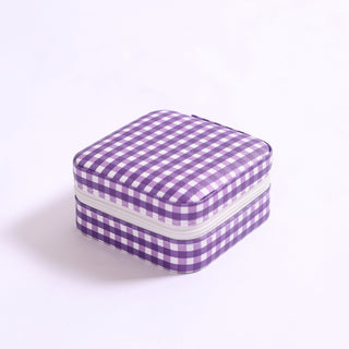 Compact square travel jewelry organizer in purple gingham print with zipper closure.