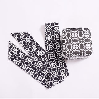 Black and white geometric floral travel jewelry case shown with matching twillie scarf accessory.