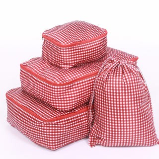 Set of red and white checkered packing cubes on a white background
