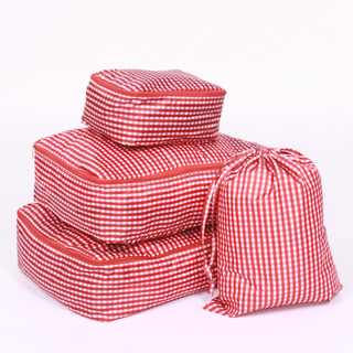 Set of maroon and white checkered packing cubes on a white background