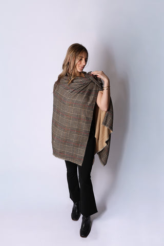 Woman wearing camel plaid Ruana styled over black pants