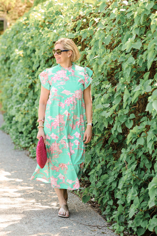 Woman wearing long dress with pink design