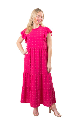 Woman wearing a pink dress with a white background