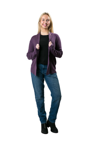 Woman in a plum open front cardigan styled with a black t-shirt and blue jeans
