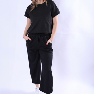 Black short sleeve sweat set with drawstring pants and raised ribbed geometric pattern