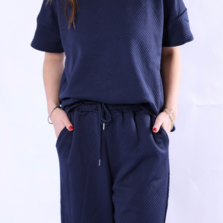 Navy short sleeve sweat set with drawstring pants and raised ribbed geometric pattern