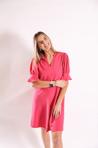 Woman wearing a pink dress against a white background