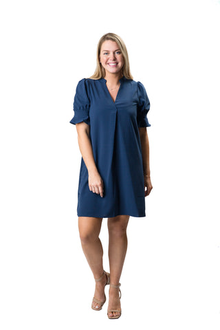 v-neck navy dress with puff sleeves and flattering front pleat