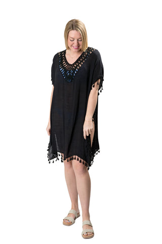 Black Cassandra cover-up with tassel on hems and sleeves, open knit v-neck-line and side slits
