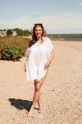 White Cassandra cover-up with tassel on hems and sleeves, open knit v-neck-line and side slits