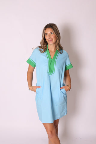 Woman wearing the Candi Color Block Dress in light blue with green accents, standing against a studio backdrop.