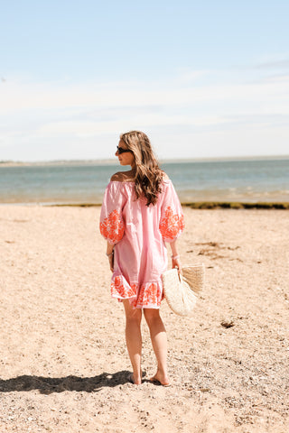 Woman wearing pink and orange cover-up
