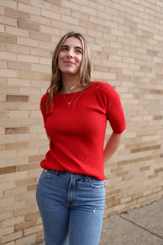 women wearing red cable knit top