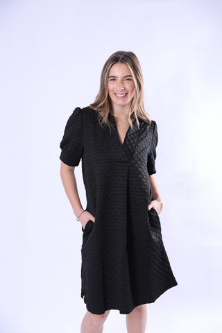 Black dress with short puffy, banned sleeves and a V-neck with collar