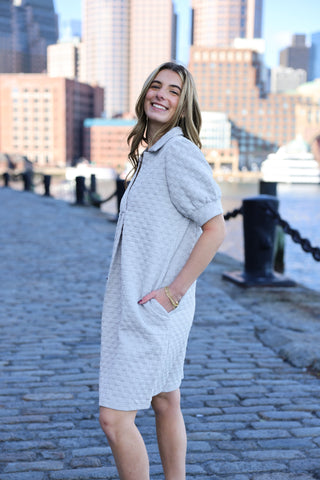 Woman wearing grey quilted dress