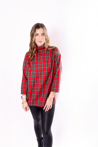 Woman wearing a red tartan plaid shirt with a ruffle collar and 3/4 sleeves