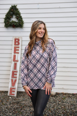 Woman wearing pink plaid top