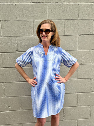 Woman wearing a blue and white striped dress