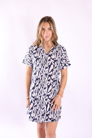 Studio image of Lottie Shirt Dress â€“ Woman wearing navy and white coastal print short sleeve shirt dress, styled simply for a modern casual look.