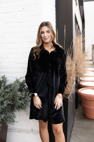 Black velvet dress at above the knee length with long sleeves. V neck collard neckline with buttons down the dress