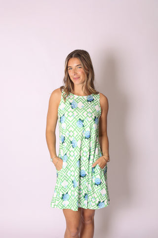 Woman wearing sleeveless A-line dress with pockets in hydrangea bamboo print