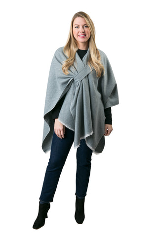 Woman modeling gray oversized cozy wrap styled over black top and jeans.