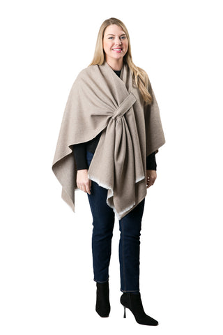 Woman modeling khaki oversized cozy wrap styled over black top and jeans.