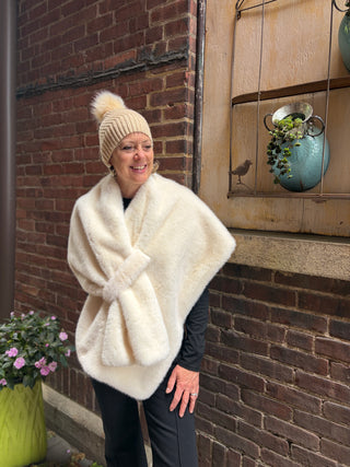 Woman wearing Chrissy ribbed knit hat with faux fur wrap, both in cream