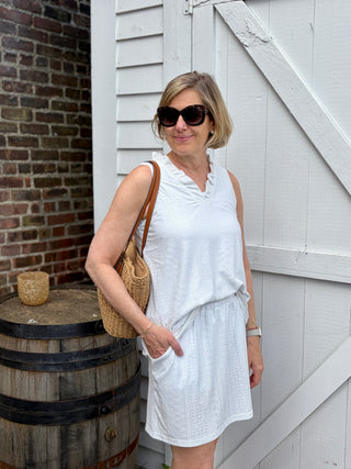 Woman wearing white eyelet skort and sleeveless V-neck top.