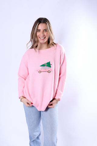 Woman wearing light pink Pippa Christmas Sweater with buggy and Christmas tree embroidery.