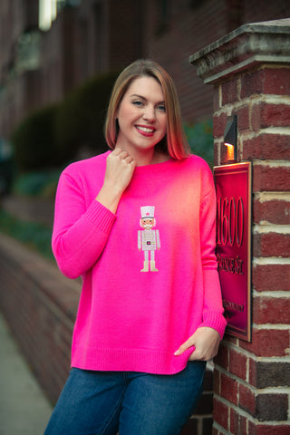 Woman wearing a pink nutcracker sweater