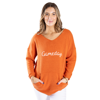Burnt orange sweater with white gameday lettering and pockets