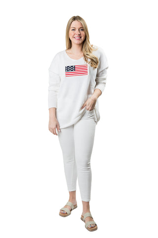 Woman wearing a white outfit with an American flag design on