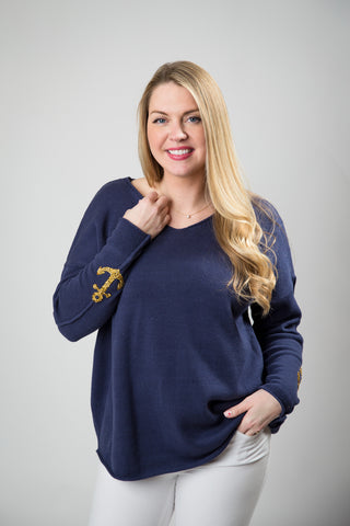 blue sweater with gold sparkle anchor motifs on sleeves